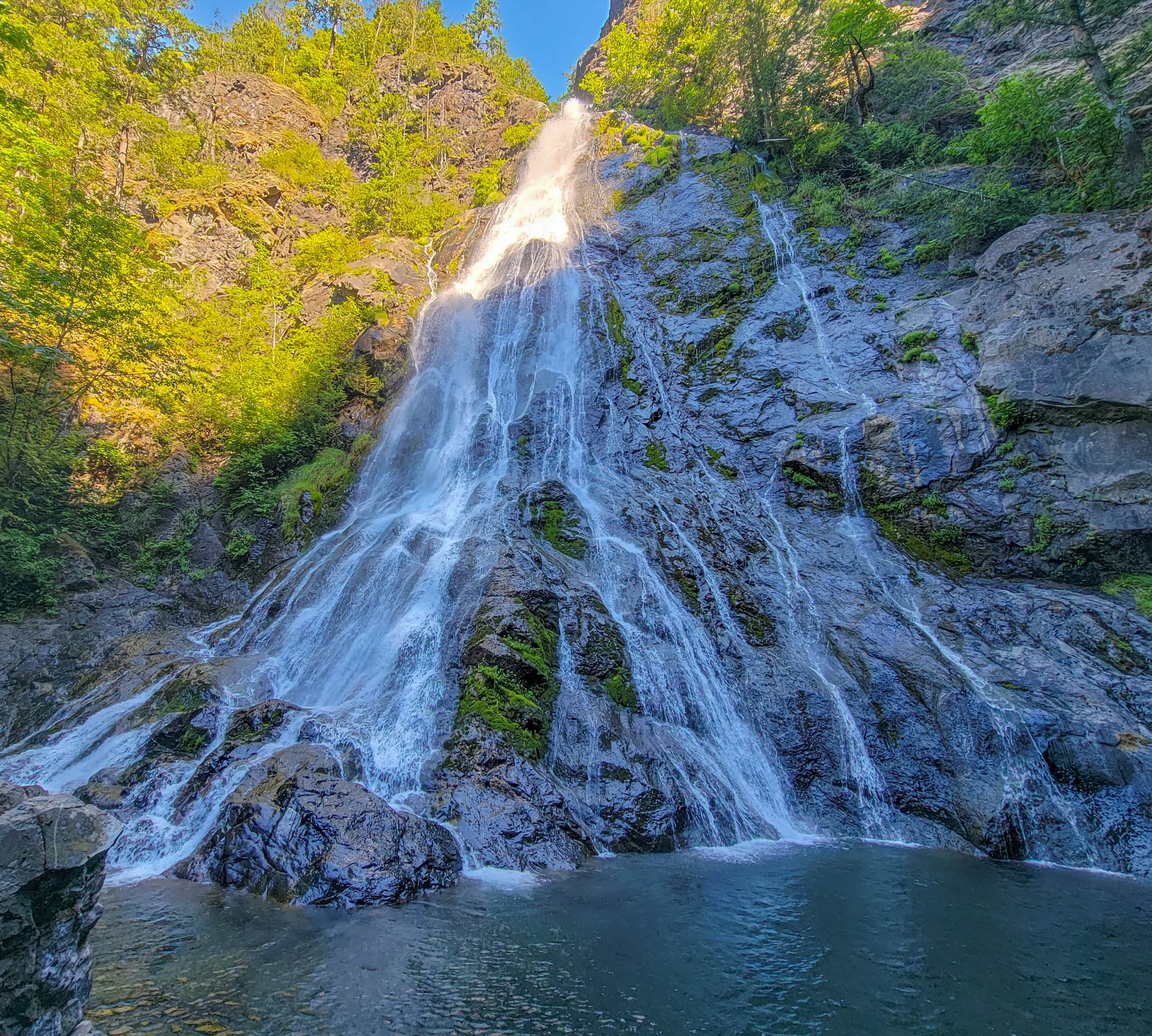 Rocky Brook Falls fanning down bedrock into its plunge pool near Brinnon, Washington
