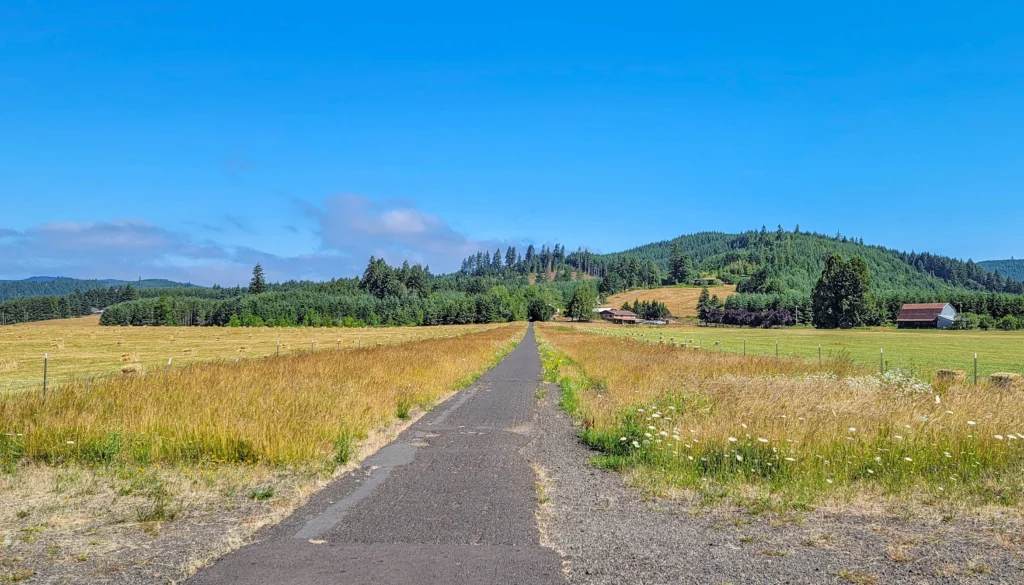 Open farmland with hay bales along the Banks-Vernonia State Trail