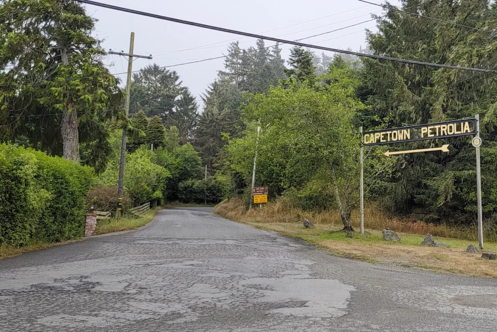 The Capetown and Petrolia junction sign on Mattole Road, with a King Range National Conservation Area sign warning that motor homes and trailers are not advised
