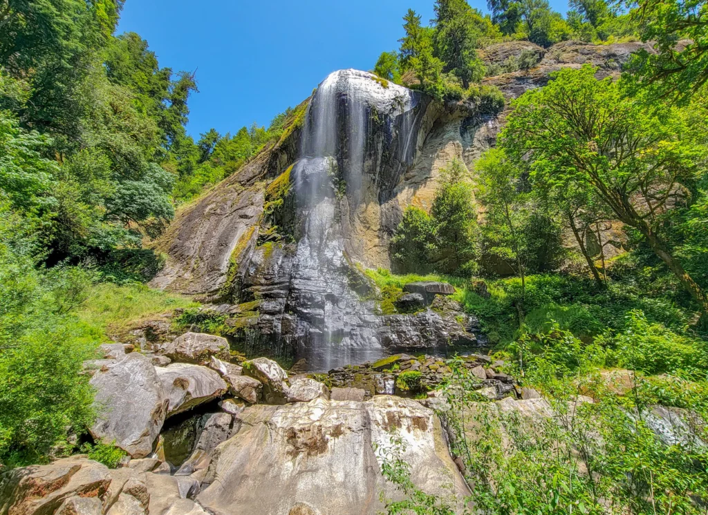 Silver Falls pouring over its rounded rock face in Golden and Silver Falls State Natural Area, Oregon