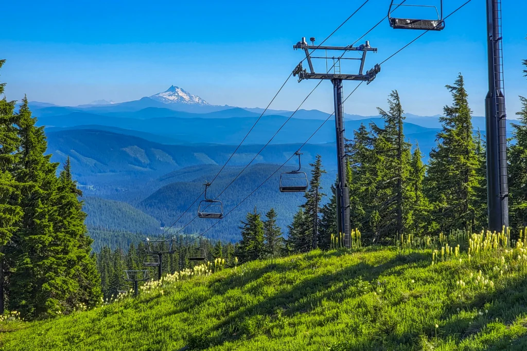 Chairlift above beargrass in bloom with Mount Jefferson beyond, Timberline, Oregon