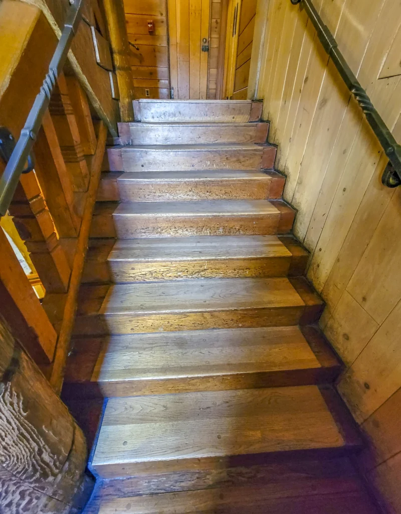 Interior staircase of heavy timber and hand-worked wood at Timberline Lodge